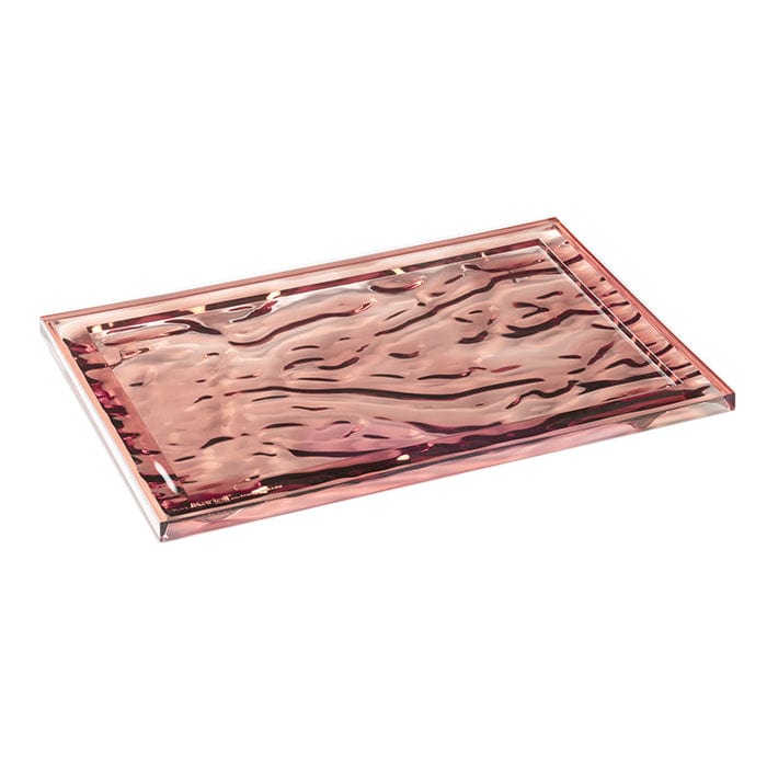 A side eye view of a pink transparent tray by Kartell.
