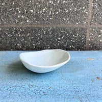 Side view of grey ceramic bowl. 
