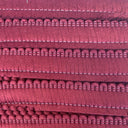 A close up of a burgundy cushion fringe.