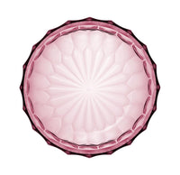 A birds eye view of a pink transparent salad bowl by Kartell.