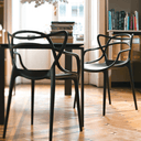 Two Kartell masters chairs in dining area.