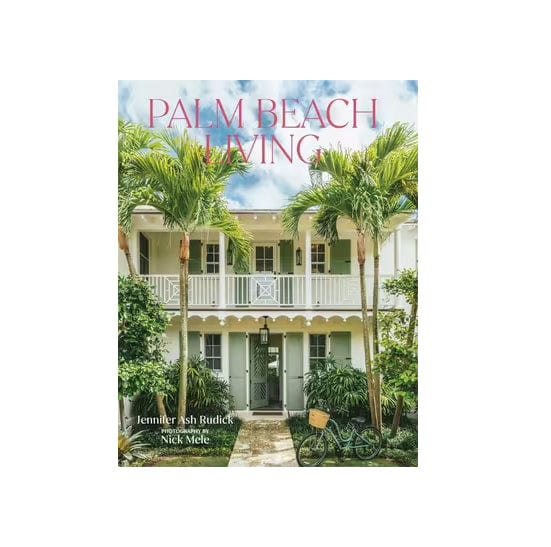 A book cover featuring the text Palm Beach Living on front of a two storied house with tall palm trees in front of it.