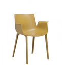 A mustard Piuma armchair by Kartell.