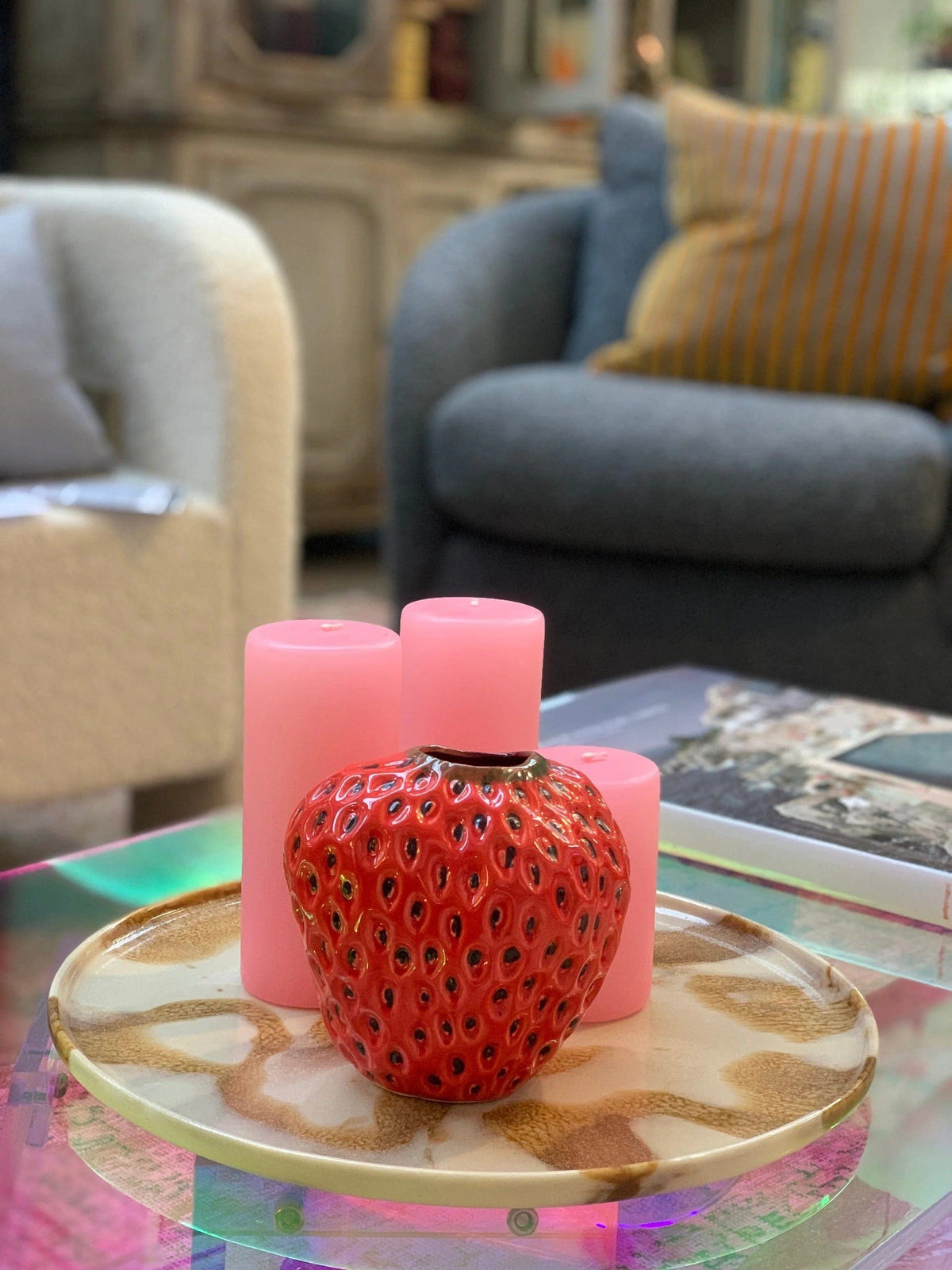 A 12cm strawberry vase on a coffee table