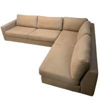 A natural brown coloured modular sofa with four seats.