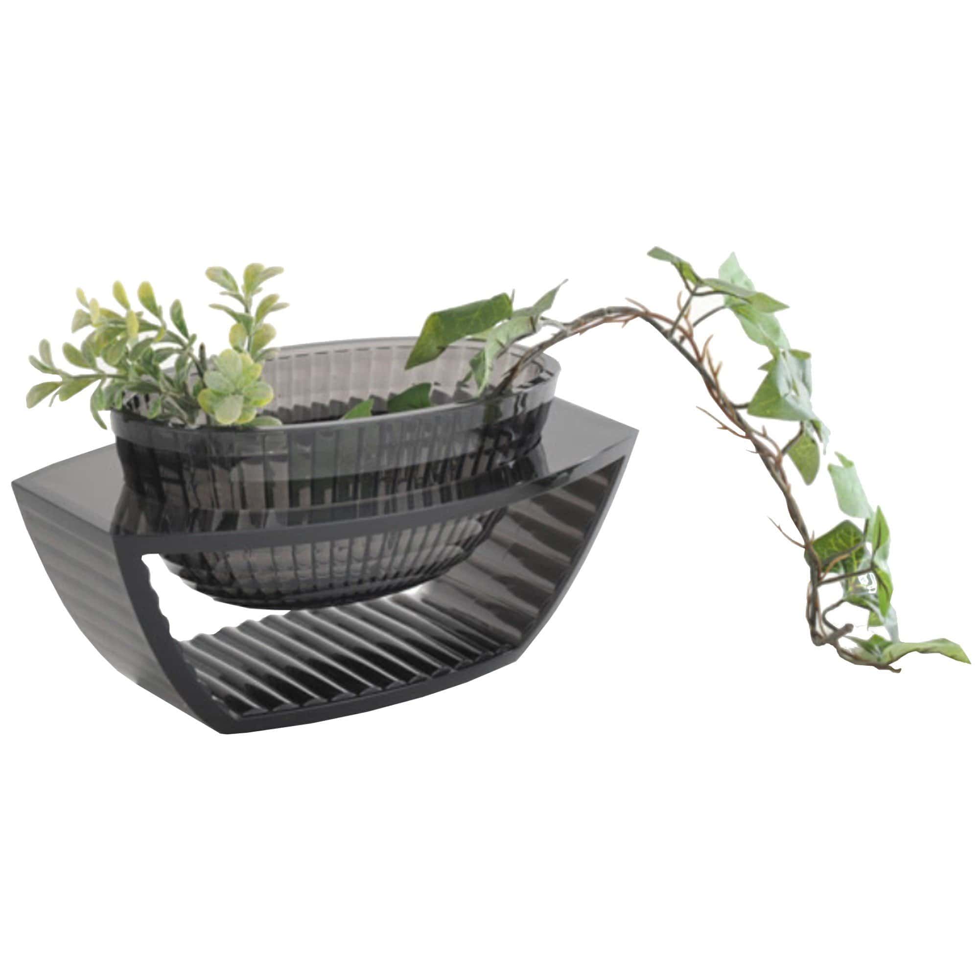 A smoke grey coloured centrepiece with a plant inside it.