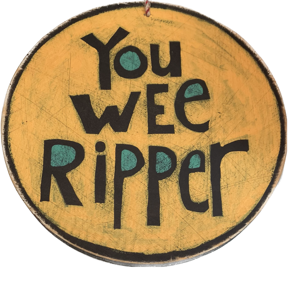 A round piece of wall art saying 'You wee ripper' on a yellow background.