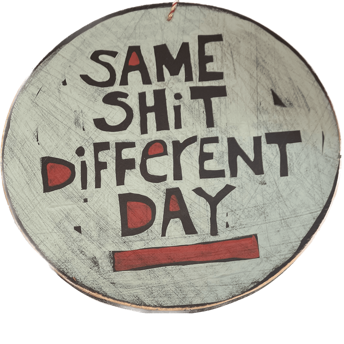 A round piece of wall art saying Same Shit Different Day.